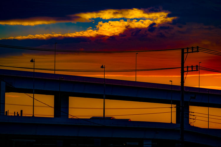 Low angle view of silhouette bridge against sky during sunset