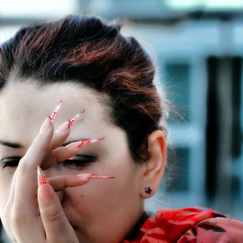 Close-up of woman with painted fingernails