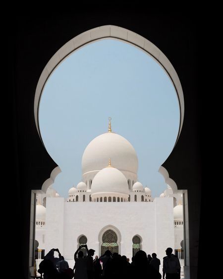 A group of people inside sheikh zayed mosque in abu dhabi