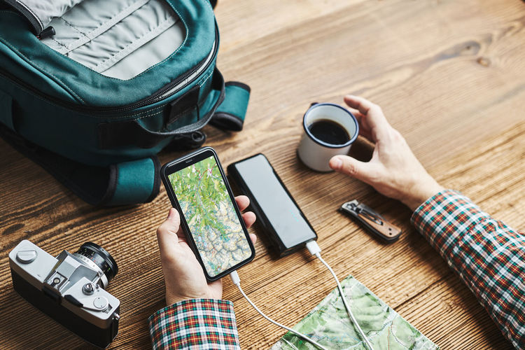 Man planning next vacation trip while journey searching travel destination using map on smartphone