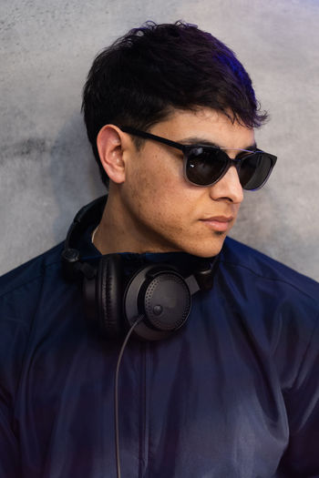 Portrait of dj wearing sunglasses and headphones