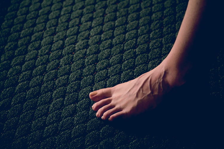 Low section of person on carpet