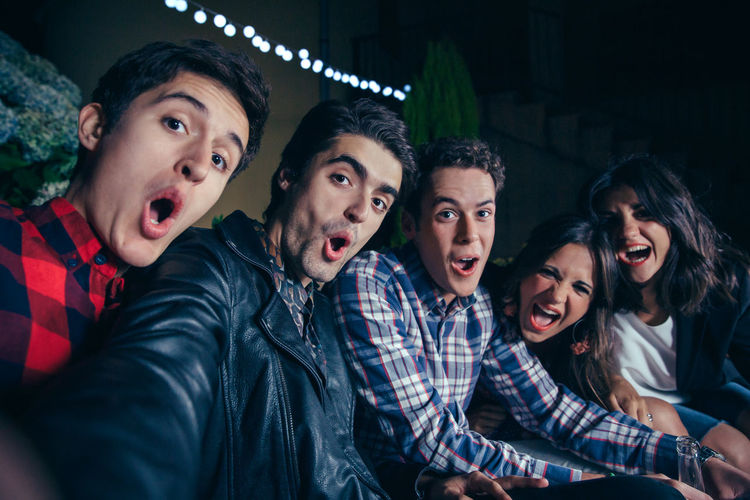 Portrait of friends enjoying in party at night