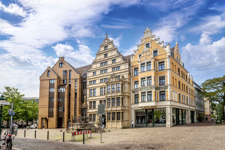 Street and buildings in city against sky