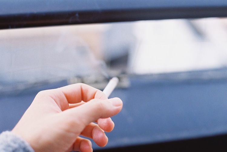 Cropped hand of person with cigarette