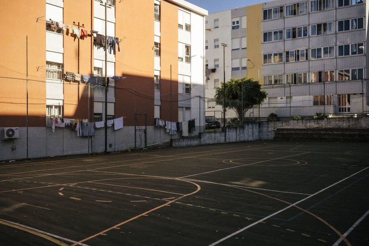 Low angle view of basketball hoop against buildings in city