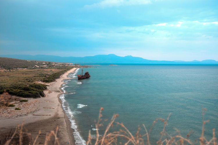 Scenic view of sea against cloudy sky