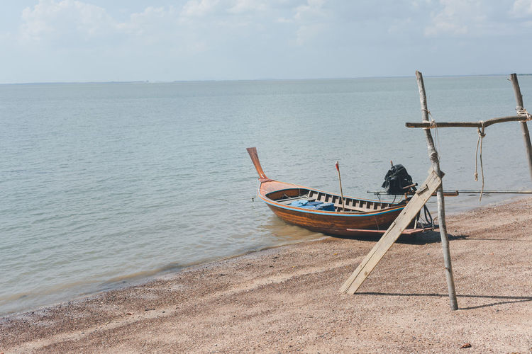 Wooden boat moored on shore