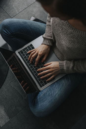 Womans hands using laptop