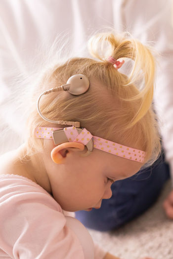 Side view of girl wearing hearing aid