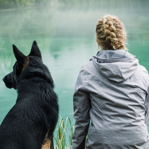 Rear view of woman with dog looking at view