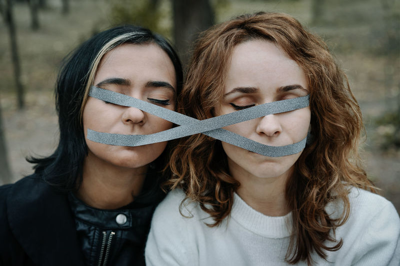 Women with adhesive tapes on face