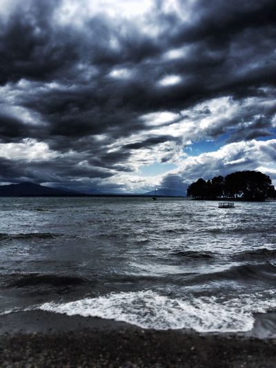 Scenic view of sea against cloudy sky