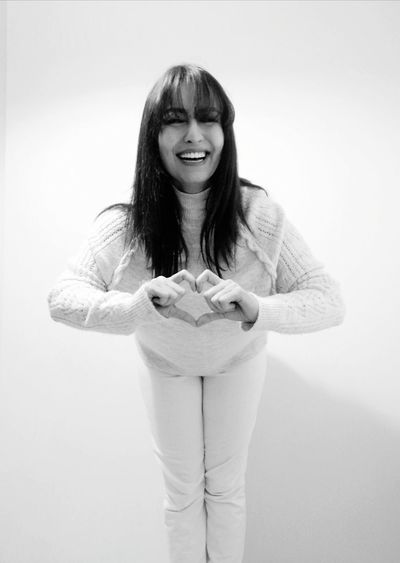 Portrait of a smiling young woman against white background