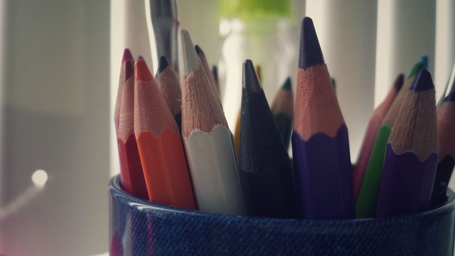 Close-up of colored pencils in desk organizer