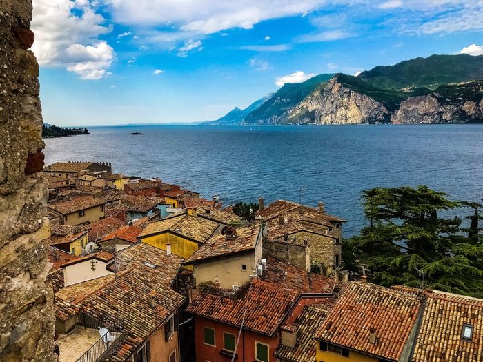 High angle view of sea and houses against sky