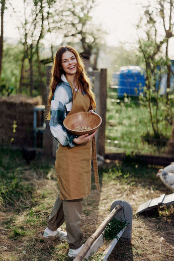 Smiling woman standing in farm