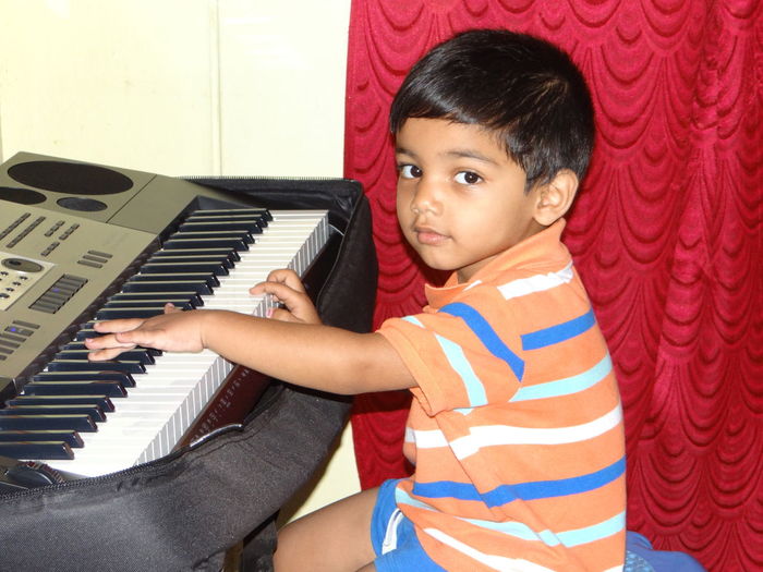 Portrait of boy playing piano
