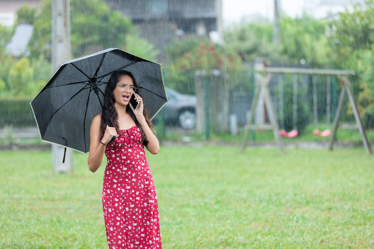 Young woman holding umbrella