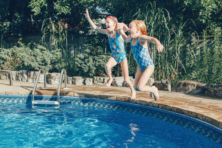 Woman jumping in swimming pool
