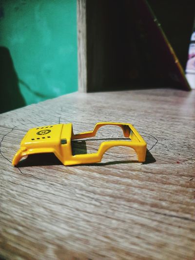 Close-up of yellow toy car on table