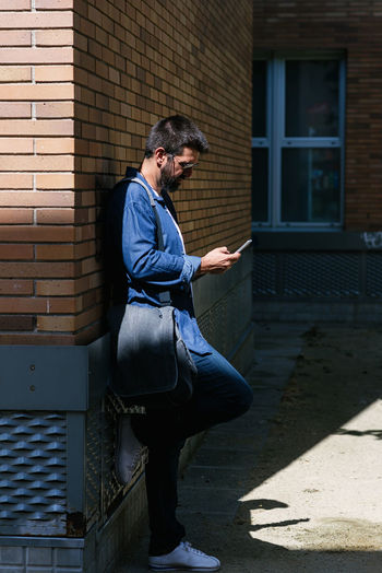 Side view of man against wall