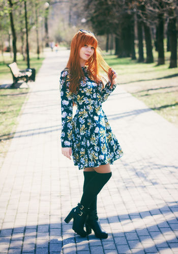 Full length of young woman standing in park