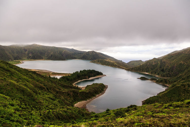 Scenic view of lake and mountains against sky