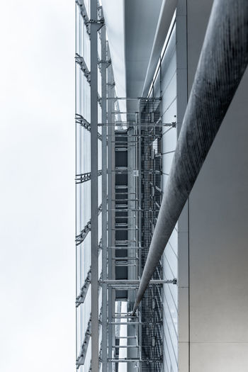 Low angle view of staircase by building against sky