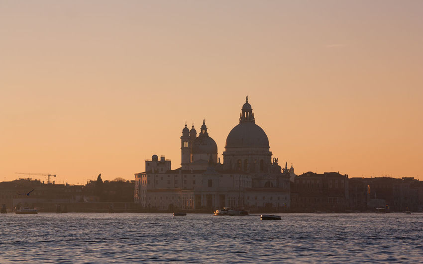 Grand canal against santa maria della salute during sunset