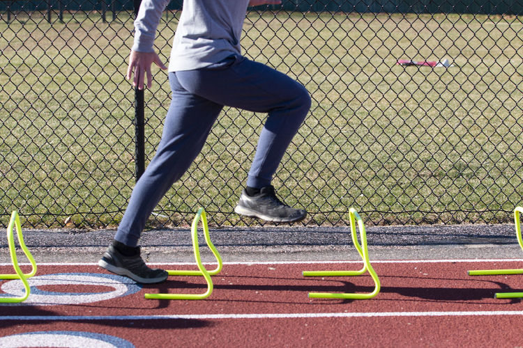 Low section of man running on court
