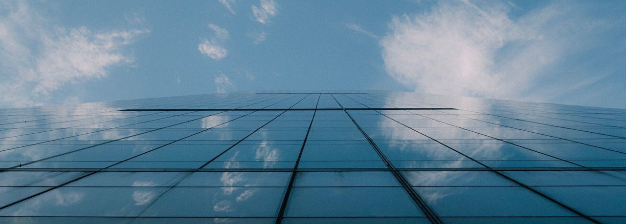 Low angle view of modern building against blue sky