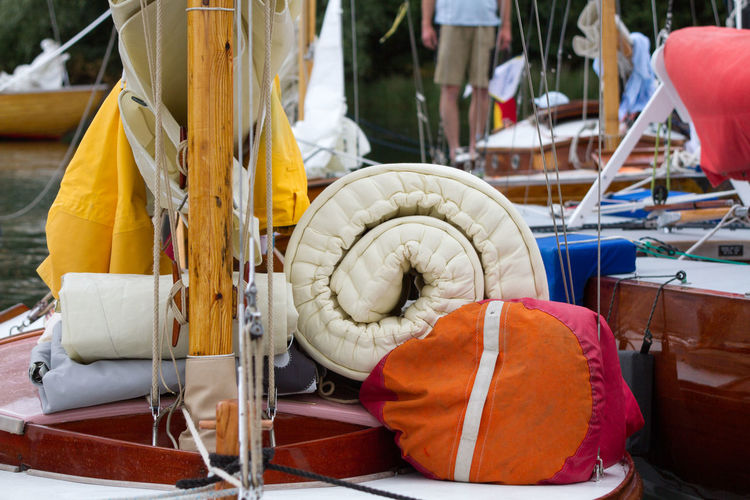 Close-up of luggage near mast on boat