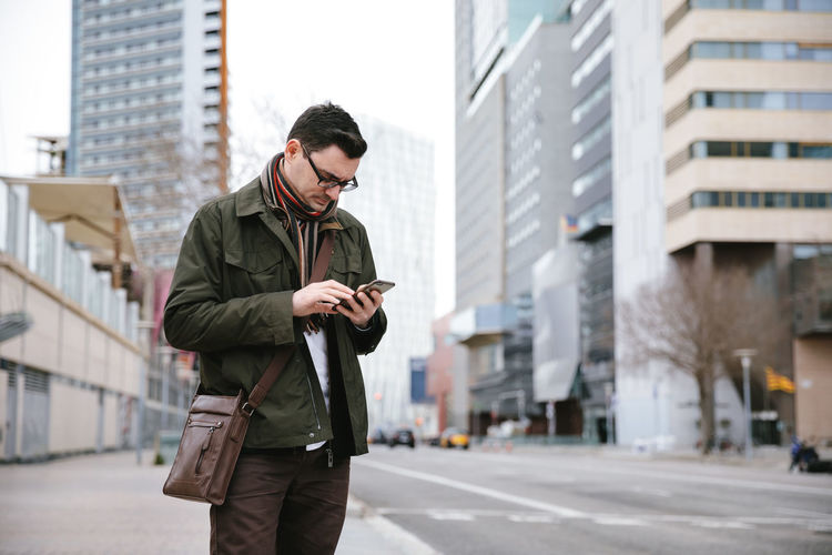 Man using mobile phone in city