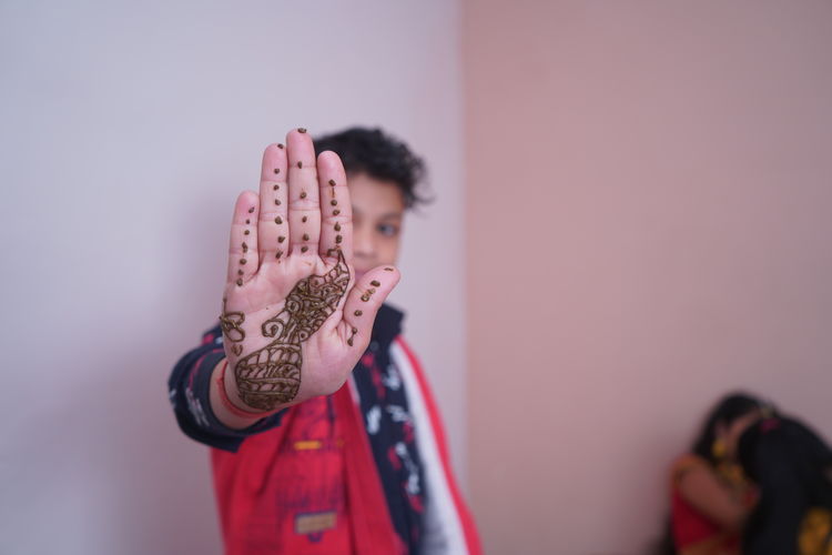 Boy showing henna tattoo
