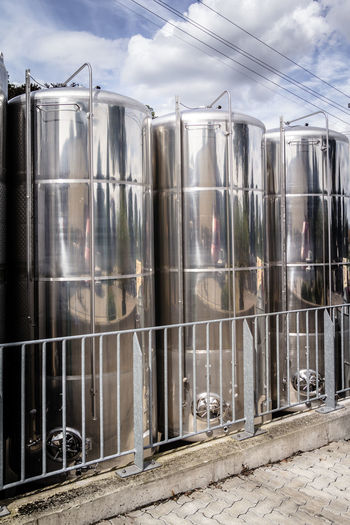 View of storage tank against cloudy sky