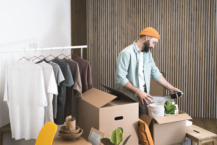 Adult man moving in new unfurnished apartments