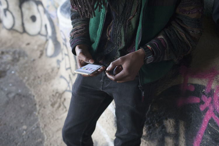 Young man holding a cell phone.