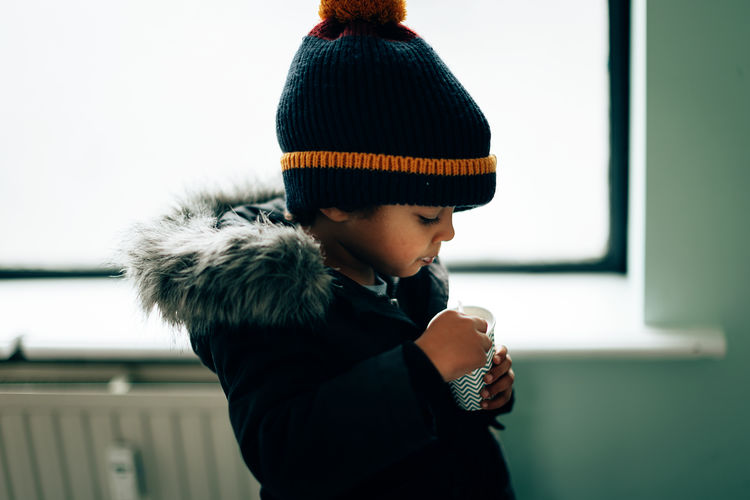 Cute mixed race child eating milkshake