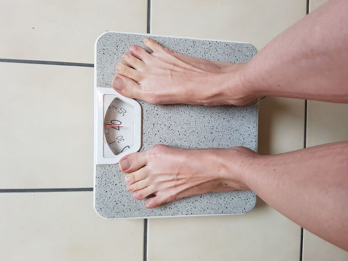 Woman weighs herself