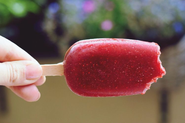Hand holding strawberry ice cream