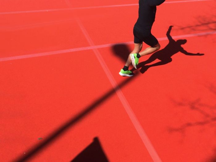 Low section of happy runner crossing finish line
