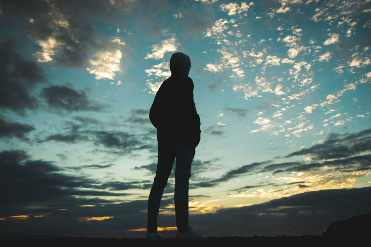 Silhouette man standing against sky during sunset
