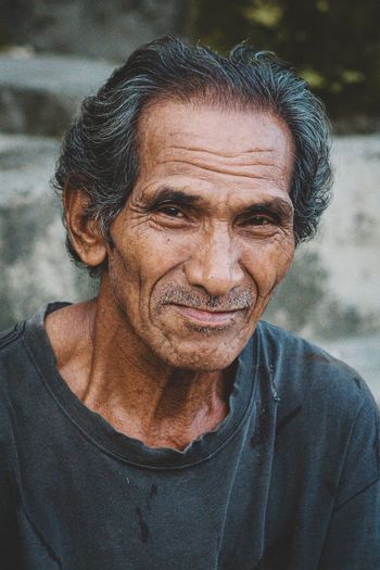 Close-up portrait of old man looking away