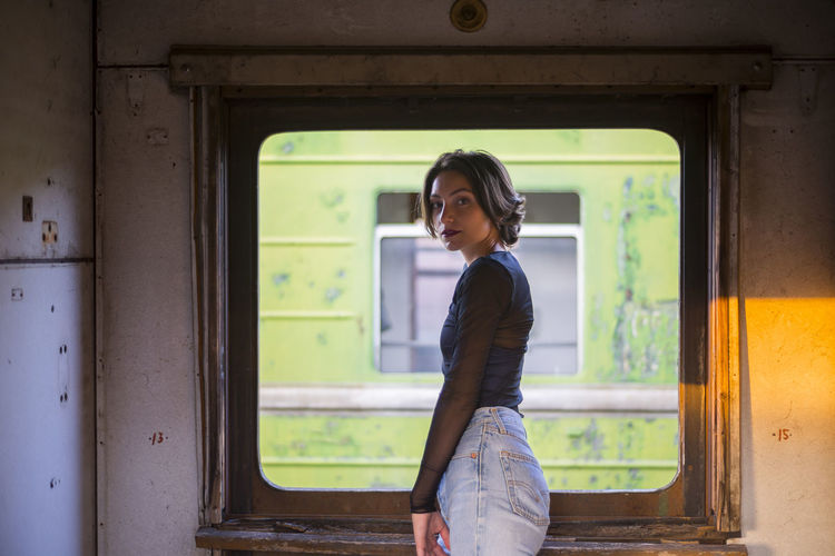 Portrait of beautiful woman standing in train