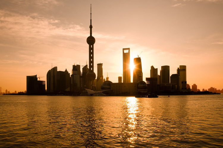 Skyline of pudong and lujiazui at sunrise across the huangpu river, shanghai, china, asia