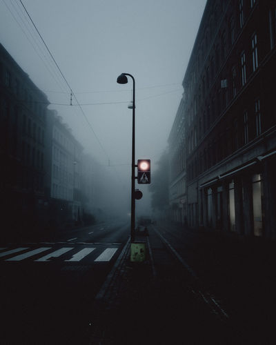 Road amidst buildings against sky in city