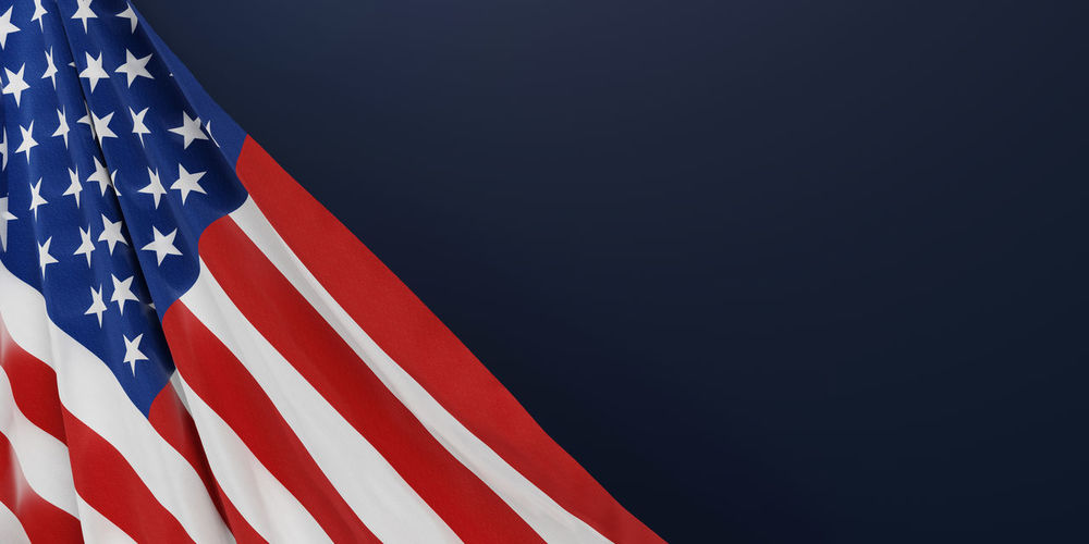 Close-up of american flag against blue background