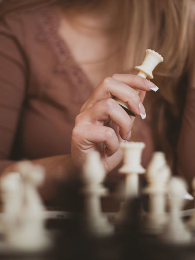 Midsection of woman playing chess