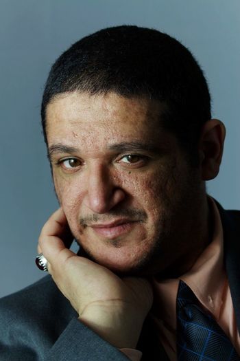 Close-up portrait of businessman against gray background